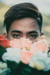 focus photo of man with flowers thumbnail
