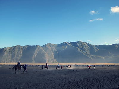 people riding horse on desert during daytime thumbnail