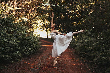 woman dancing ballet near trees thumbnail