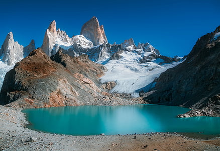 body of water surrounded by mountain thumbnail