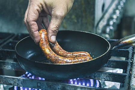 person cooking sausage thumbnail