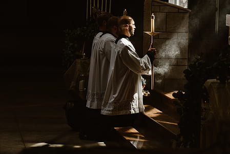 three men kneeing in front of altar thumbnail