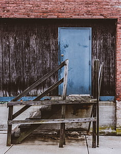 brown wooden stairs beside blue wooden closed door thumbnail