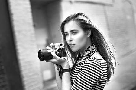 Grayscale Photo of Woman Holding a Dslr Camera thumbnail