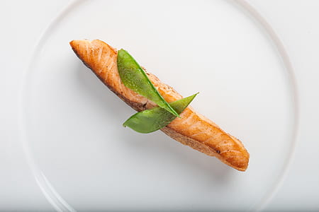 Cooked Fish With Two Green Leaf on Round White Ceramic Plate thumbnail