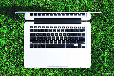 Overhead view of laptop computer in grass thumbnail