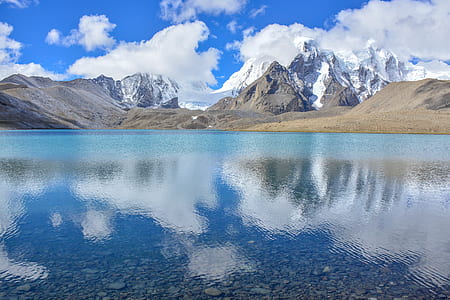 landscape photography of snowy mountain under cloudy sky thumbnail