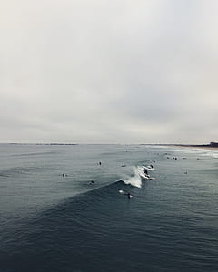 people surfing on ocean wave thumbnail