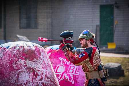 man holding blue and red gun thumbnail
