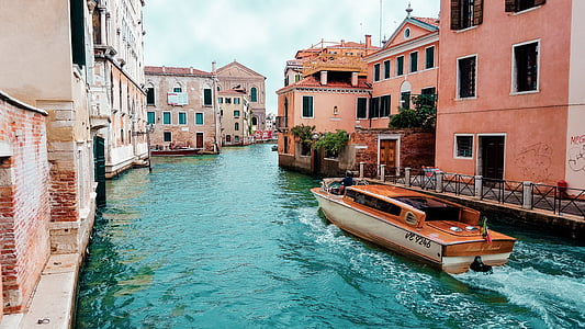 brown boat on grand canal between houses thumbnail
