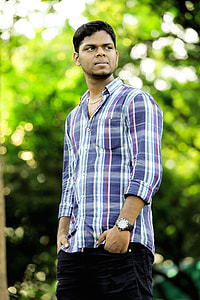 photo of man in purple and white plaid sport shirt and black pants thumbnail