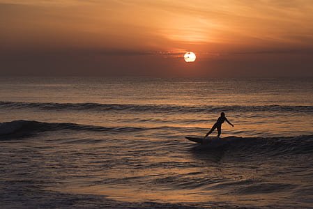 person surfing during sunset thumbnail