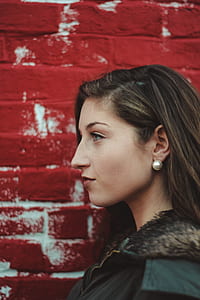 woman standing against red wall thumbnail