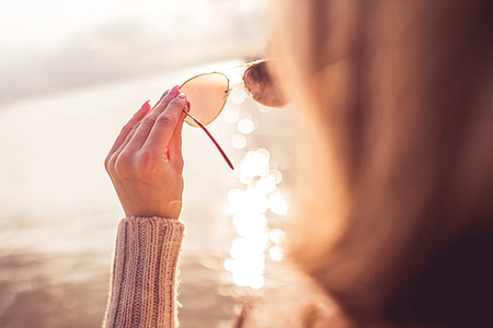 Girl Looking at the Sea Through Sunglasses thumbnail