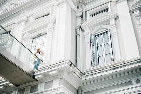woman in blue jeans standing by the terrace thumbnail