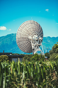 selective focus photography of parabolic antenna and mountain range view thumbnail