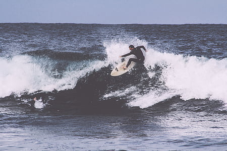 man on surfboard surfing on waves thumbnail