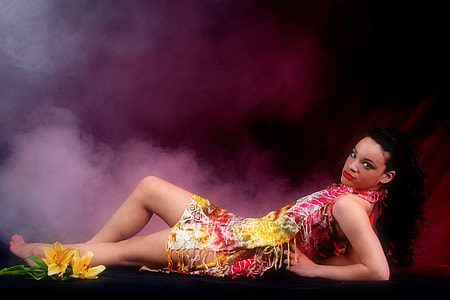 woman laying on black surface wearing red dress thumbnail