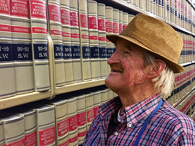 man looking at filed books thumbnail