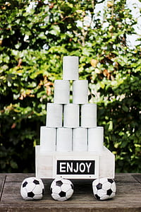 white cans near three soccer balls thumbnail
