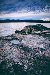 gray cliff near body of water thumbnail