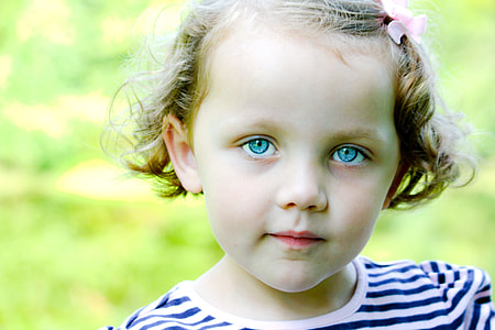 selective focus photography of girl wearing black striped shirt thumbnail