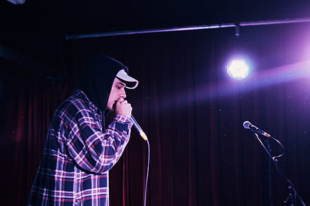 man standing while holding microphone thumbnail