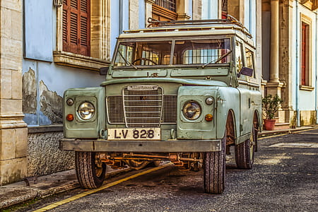 green vehicle parked near house on road thumbnail