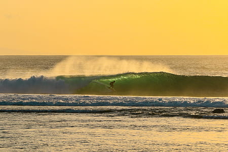 person surfboarding during daytime thumbnail