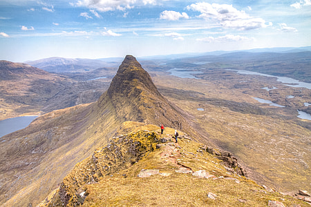 two men climbing on mountain's peak thumbnail