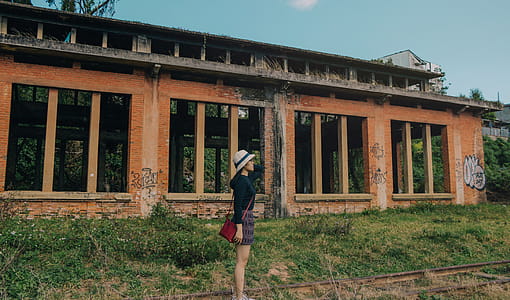 Woman Standing Near Brick Building thumbnail