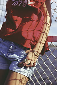 person wearing tank top and leaning on the fence thumbnail