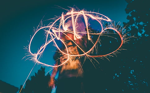 time-lapse photography of person holding sparkler thumbnail