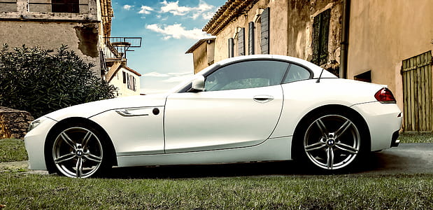white BMW Z4 coupe parked in front of house thumbnail