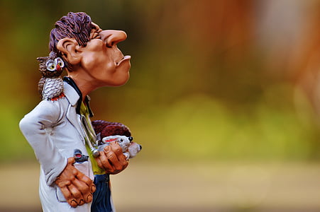 man holding rabbit with owl on right shoulder figurine thumbnail