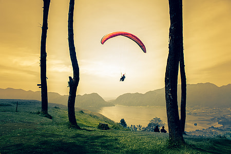 person paragliding near body of water thumbnail