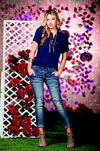 woman in blue button-up top and distressed jeans thumbnail