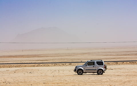 gray vehicle travelling on road thumbnail