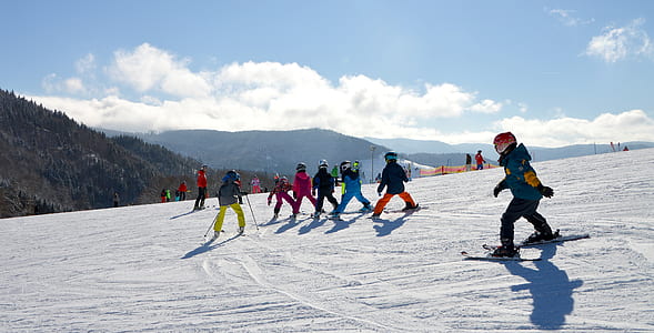 group of people skiing on snow thumbnail