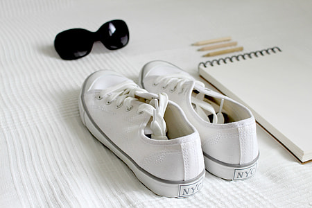 pair of white low-top sneakers on white textile thumbnail