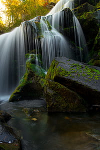 waterfalls near trees at daytime thumbnail
