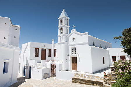 white building beside trees thumbnail