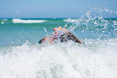 woman behind waves of body of water thumbnail