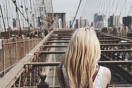 woman standing near bridge at daytime thumbnail
