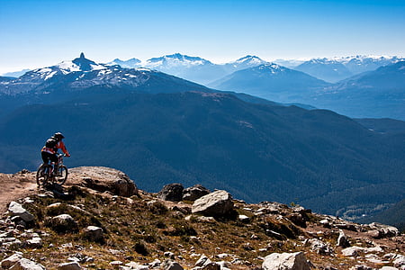 person riding a bike on mountain during daytime thumbnail