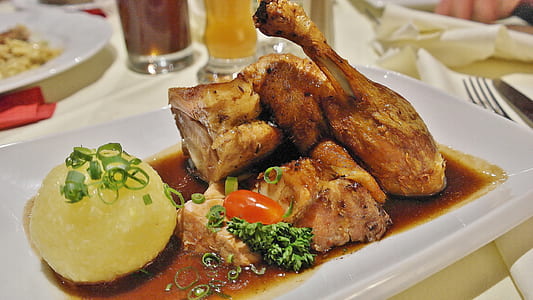 serving of roasted chicken on white ceramic dinner plate thumbnail