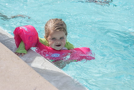 girl wearing pink arm ring vest in pool thumbnail