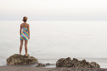 woman in multicolored sleeveless dress standing thumbnail