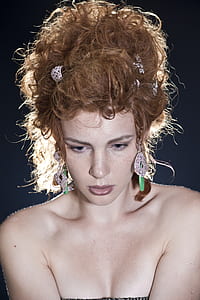 woman with blonde hair wearing earrings thumbnail