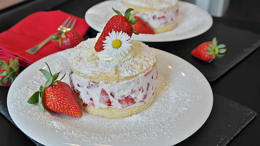 white icing-coated cake with strawberry on plate thumbnail
